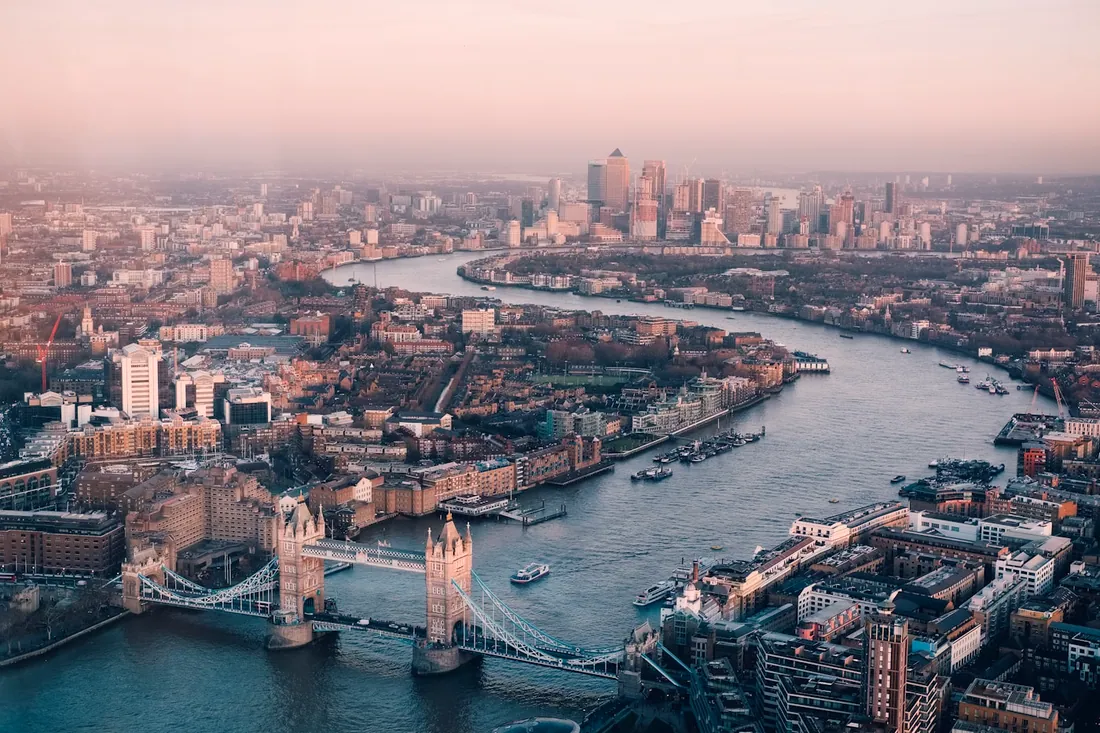 London at dusk along the Thames as the city lights come on